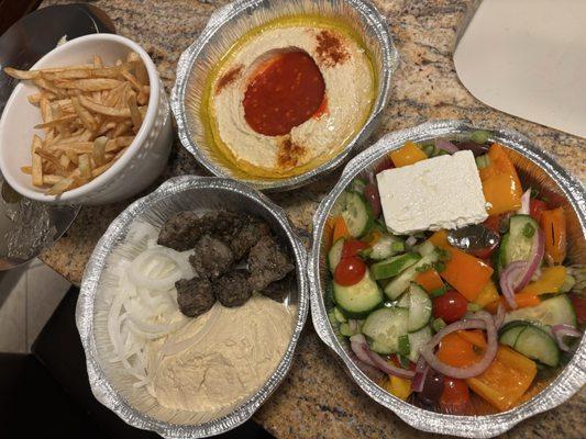 fries, hummus with crushed red pepper topping, kafta plate, greek salad