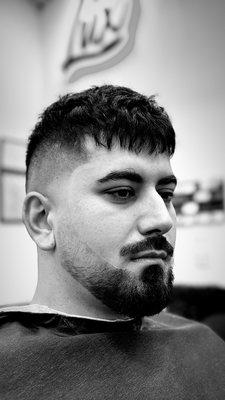 Crop top with a skin fade on the sides and a light touch up on the beard.