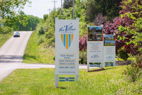 Logo and roadside signage for The Villas at Woodson Bend.