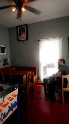 The family waiting area. Needs some serious attention, there were boxes of supplies (cables and??) under the two pinball machines.