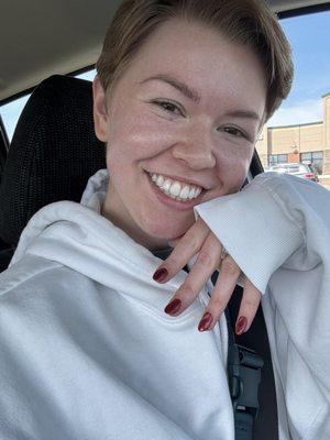 A happy customer with a fresh set of acrylics