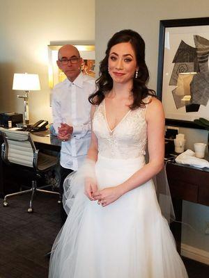 The lovely bride, with her father looking on, adoringly.