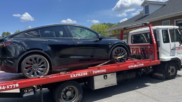 My Tesla with flat tire getting towed to the tires plus