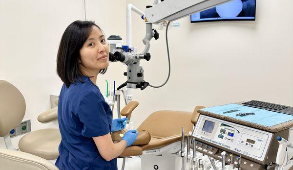 Dr. Snow Feng, DMD (endodontist / root canal specialist) using Zeiss microscope and endodontic instruments to perform a root canal treatment