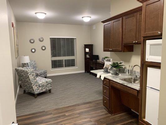 Spacious living room and kitchenette. Walk in further to see the equally large bedroom, bathroom and closet area. Respite care is available.
