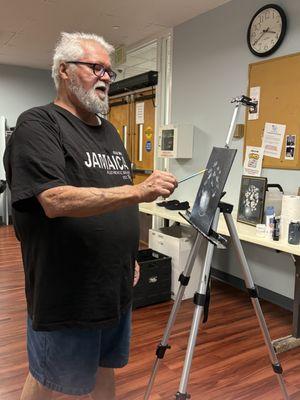 Paul demonstrating his signature wet-on-wet technique-decades of experience shared with patience and passion.