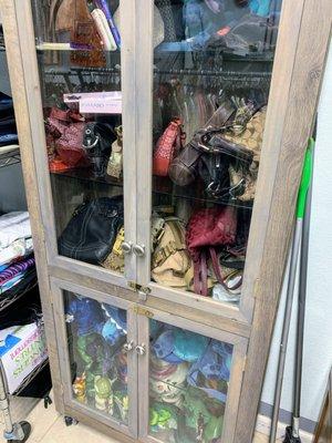 Designer bags, such as Coach, in this showcase