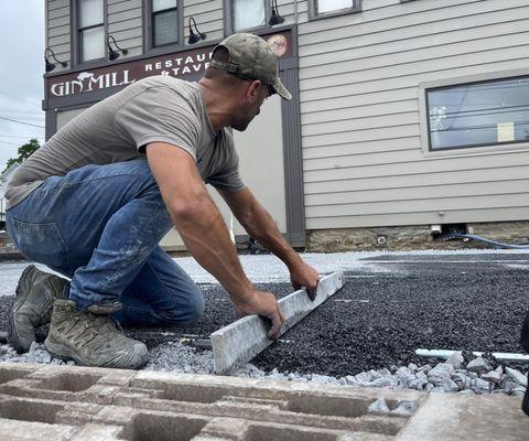 Screeding base stone for a paver patio