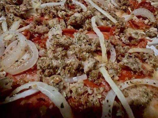 Close up of our Sausage, Pepperoni & onion pizza.