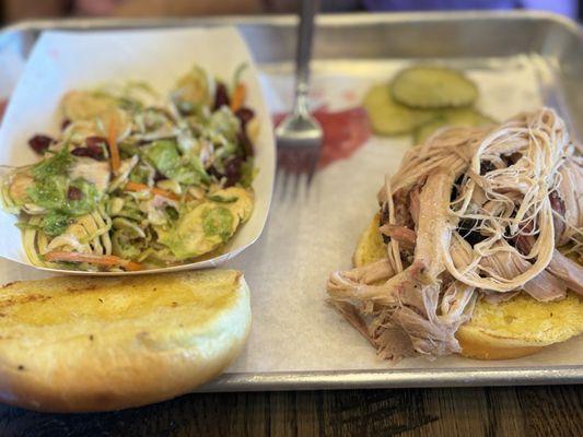 Pulled pork sandwich with a small side of Brussels slaw