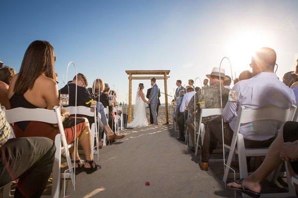 Shot of the ceremony, with the ocean in the background.