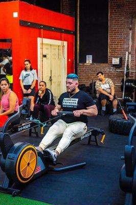 Trainer Alex demonstarting Ski Row exercise
