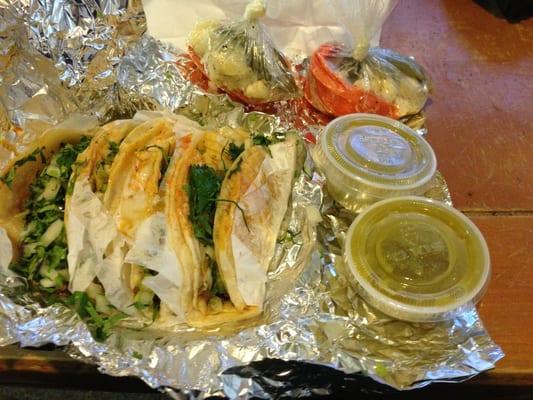 Steak and chorizo (Mexican sausage) tacos. Green salsa, and spicy vegetables.
