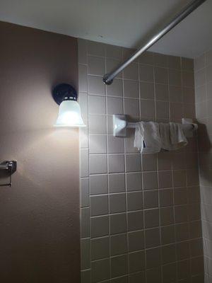 This is not a waterproof, bathroom safe sconce. They do exist, why hasn't the hotel changed the fixture to something more safe?