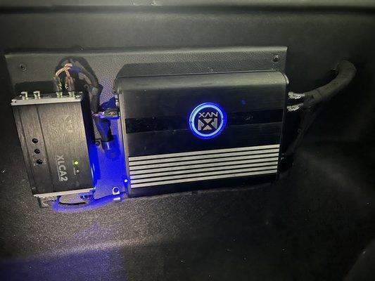 Closer look at the mounting and containment of cable work of the amp in the frunk.