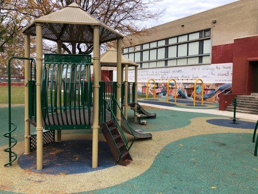 Small children's playground behind building