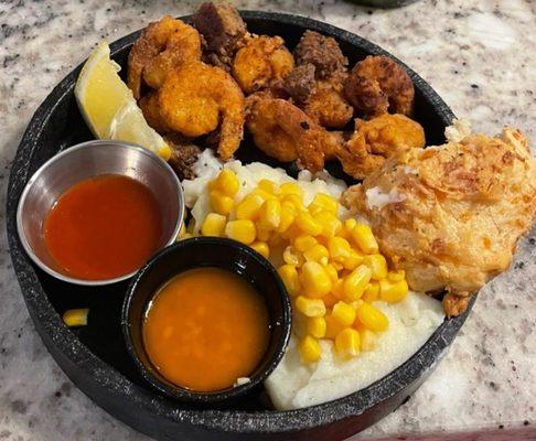Fried shrimp,mash potatoes, biscuit, corn, and steak