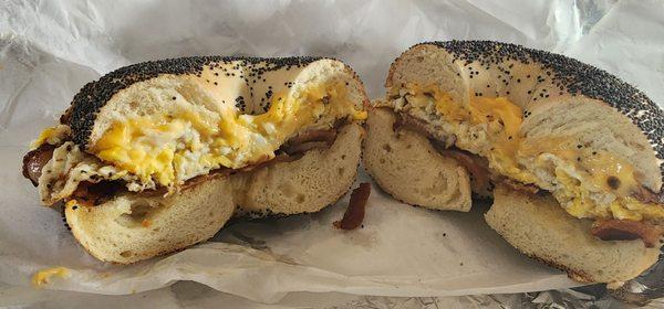 Bacon, egg, scrambled egg on a toasted poppy bagel.