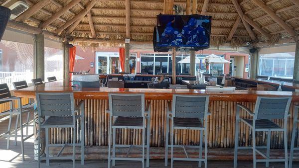 The tiki bar offers a relaxed beach vibe and four large flat screen TV's allowing our guest to enjoy entertainment in a laid-back atmosphere