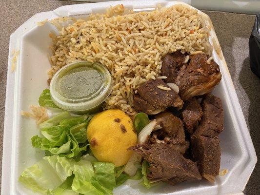 Lamb, rice, spicy green sauce.