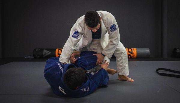 Coach Mike Davila passes the guard during live drills.