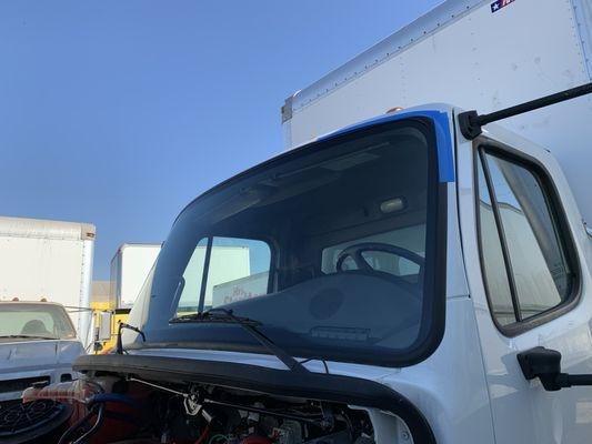 in this picture the truck has a brand new windshield. the job is completed and the customer is ready to hit the road