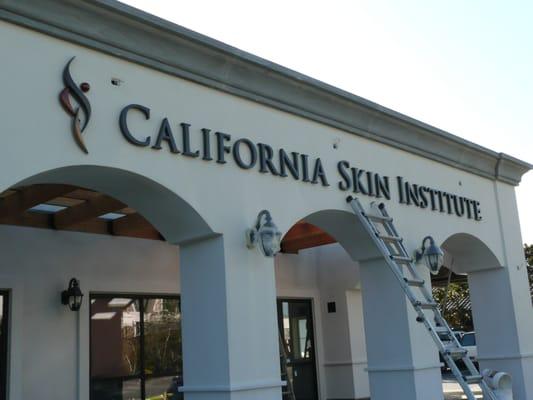 Exterior sign with carved logo shape.