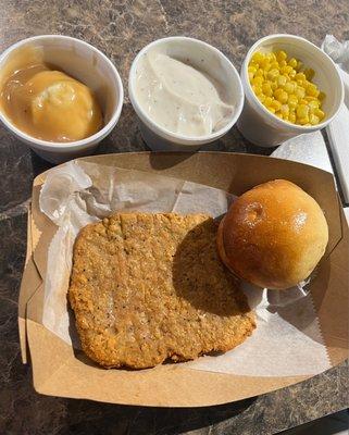Chicken fried steak with mashed potatoes, corn, gravy and roll.