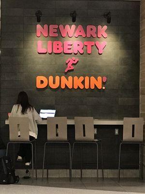 Seating area at the NEW Terminal A Dunkin Charge up your electronics & you