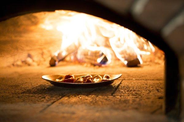 Preparing Pepi di Neti. Boosting flavor with the wood oven.