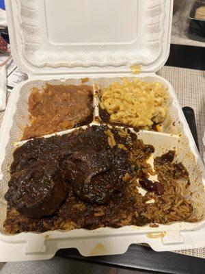 Oxtail with jollof rice, candied yams, and mac and cheese