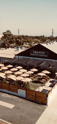 Spacious outdoor patio that hosts food trucks, live music and sports on TV's