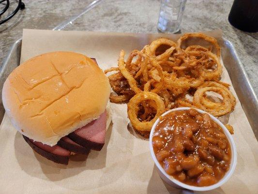 Bologna sandwich with onion rings and beans