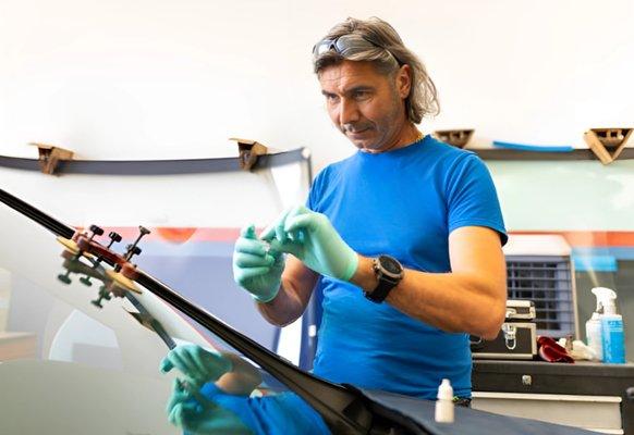 Expert technician from Swift Shield Auto Glass performing precision windshield repair using advanced tools--quick, reliable.