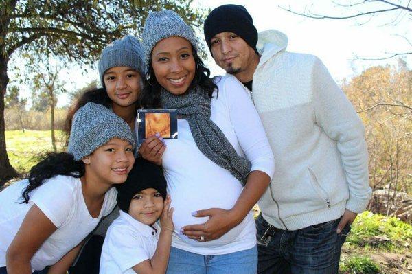 Family. The picture in this photo is the ultrasound of the baby in the tummy. Great family photo.