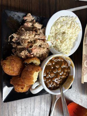 Pulled pork, hush puppies, baked beans, and mayo slaw