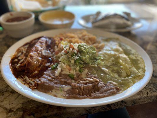 Combination plate: tamale with red sauce and cheese enchilada with green sauce.