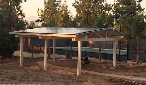 Solar panels installed on a gable roof patio cover