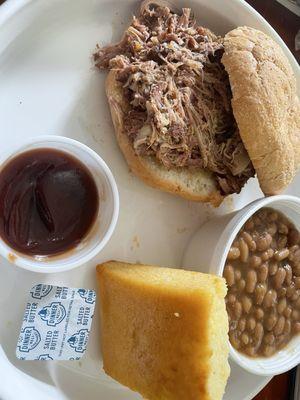 Pulled Pork Sandwich, baked beans, and cornbread