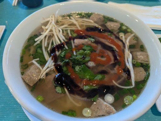 Pho with hoisin and siracha sauce.