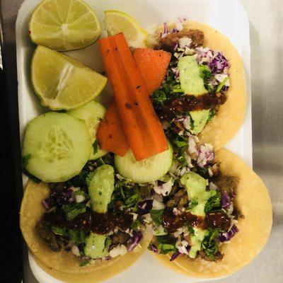 Asada Al Pastor and Pollo Tacos green avocado salsa and super hot red salsa every taco order comes with lime cucumber and pickled carrots