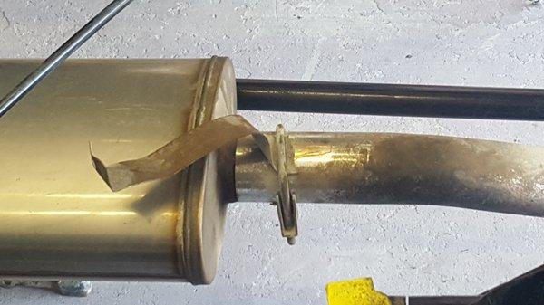 thin cheap metal on a rusty muffler