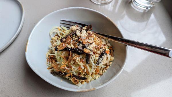 Papaya salad with daikon and cucumbers, topped with roasted peanuts and a spicy lime dressing.