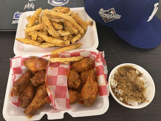 Fries, ghost pepper and spicy lemon pepper wings with a side of rice gravy