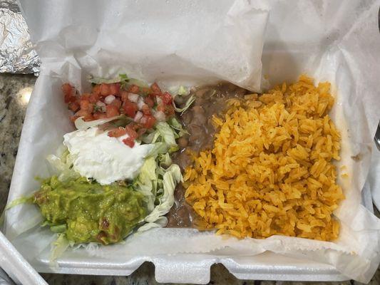Side including pico, guacamole sour cream refried beans & rice.