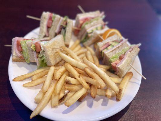 California Club! Ham, Turkey, Bacon, Avocado, lettuce, tomato plus mayo on toasted sourdough bread with fries!