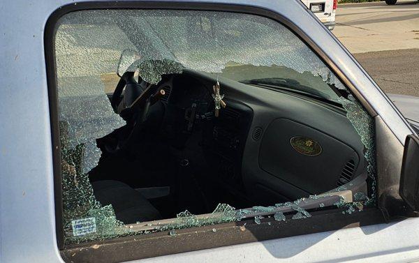 Broken glass from lawn mower shooting rock into the window.
