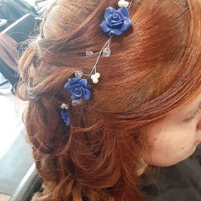 Loose curls pinned half way up for a soft, romantic style.