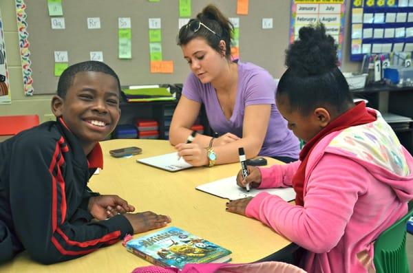 Two of our Afterschool Enrichment Program scholars at Garden Hills Elementary School, along with one of our team members!