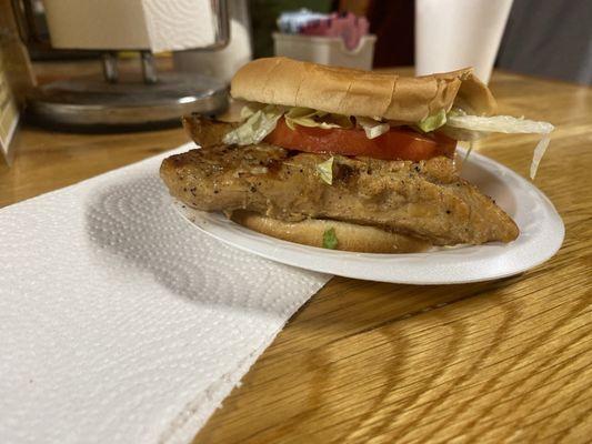 Grilled chicken sandwich with lettuce, tomato, and mayo.